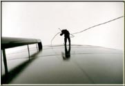 Vertical photograph of water tower surface cleaning 65 feet up