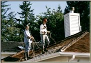 This is during the application of "Cedarguard" to this roof, along with one safetyman and the other actually applying the treatment.