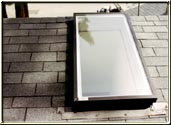 This photograph represents a simple swap out of an old leaking skylight with a new skylight.